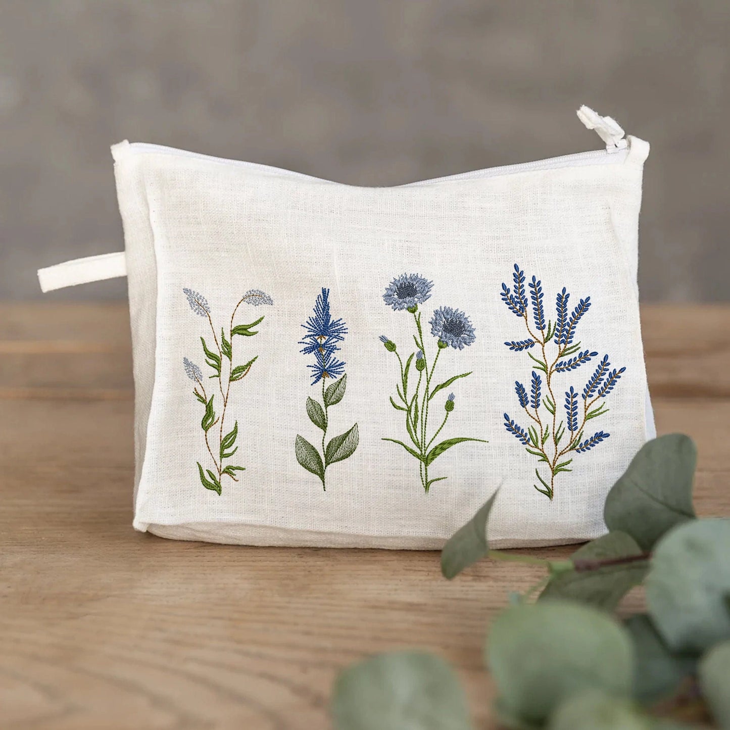Blue wild flowers flax iris, cornflower forget-me-not machine embroidery designs on cosmetic bag