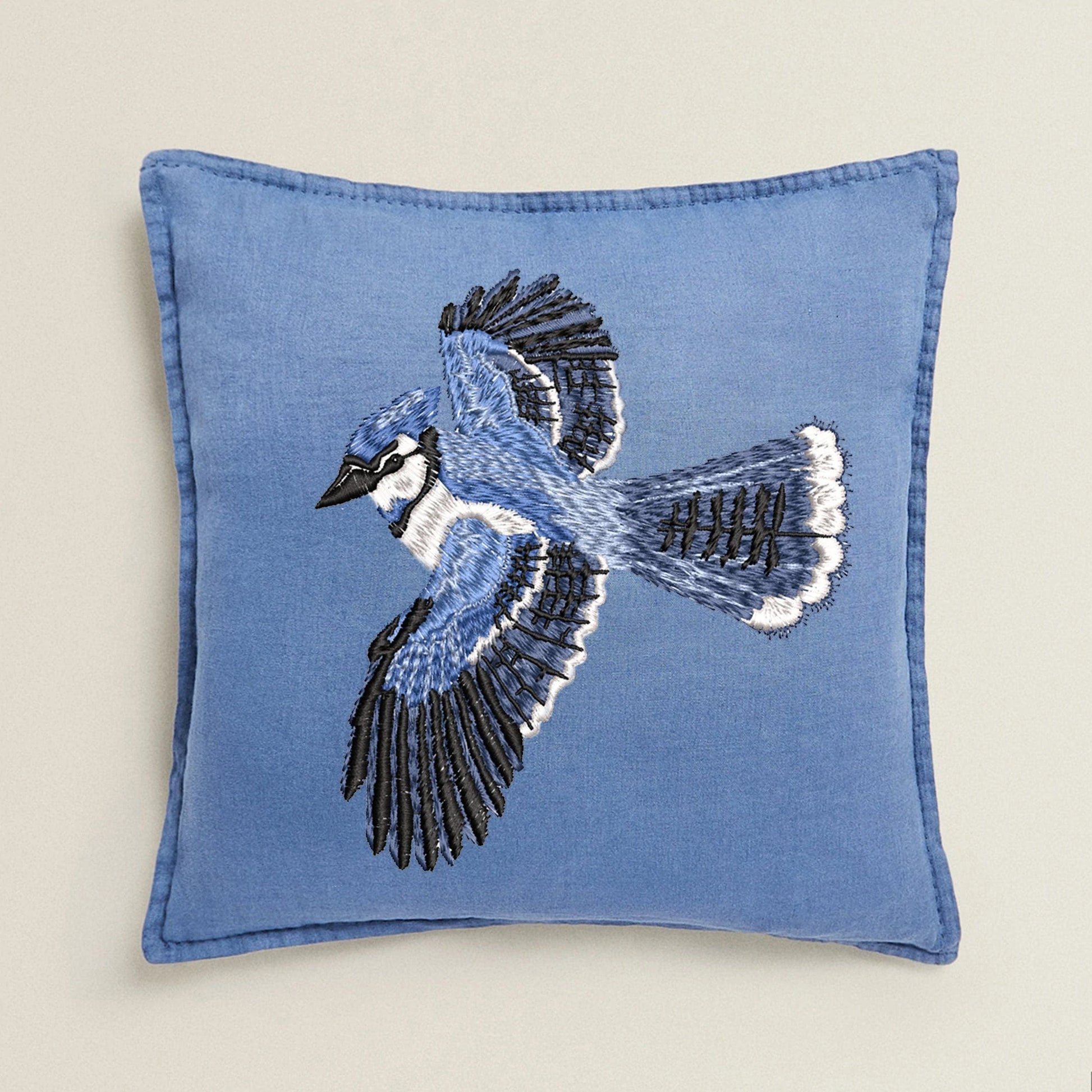 Beautiful Bluebird machine embroidery design on denim pillow