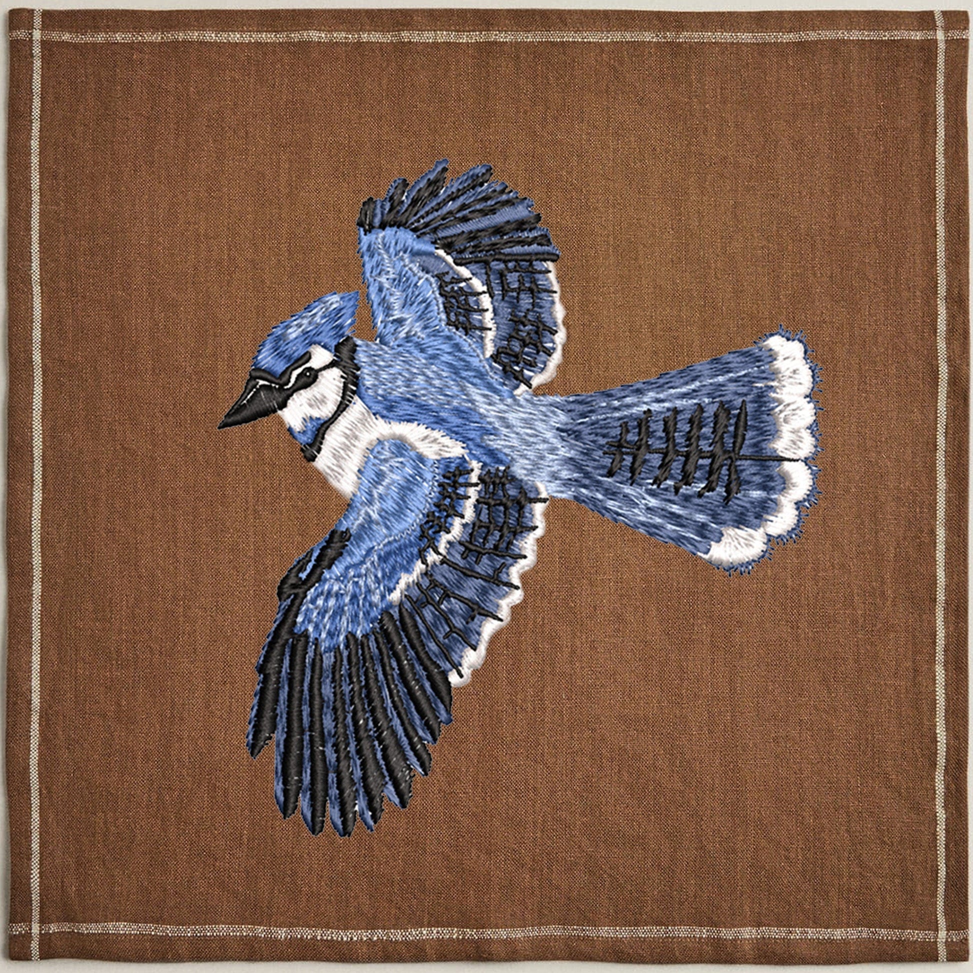 Beautiful Bluebird machine embroidery design on napkin