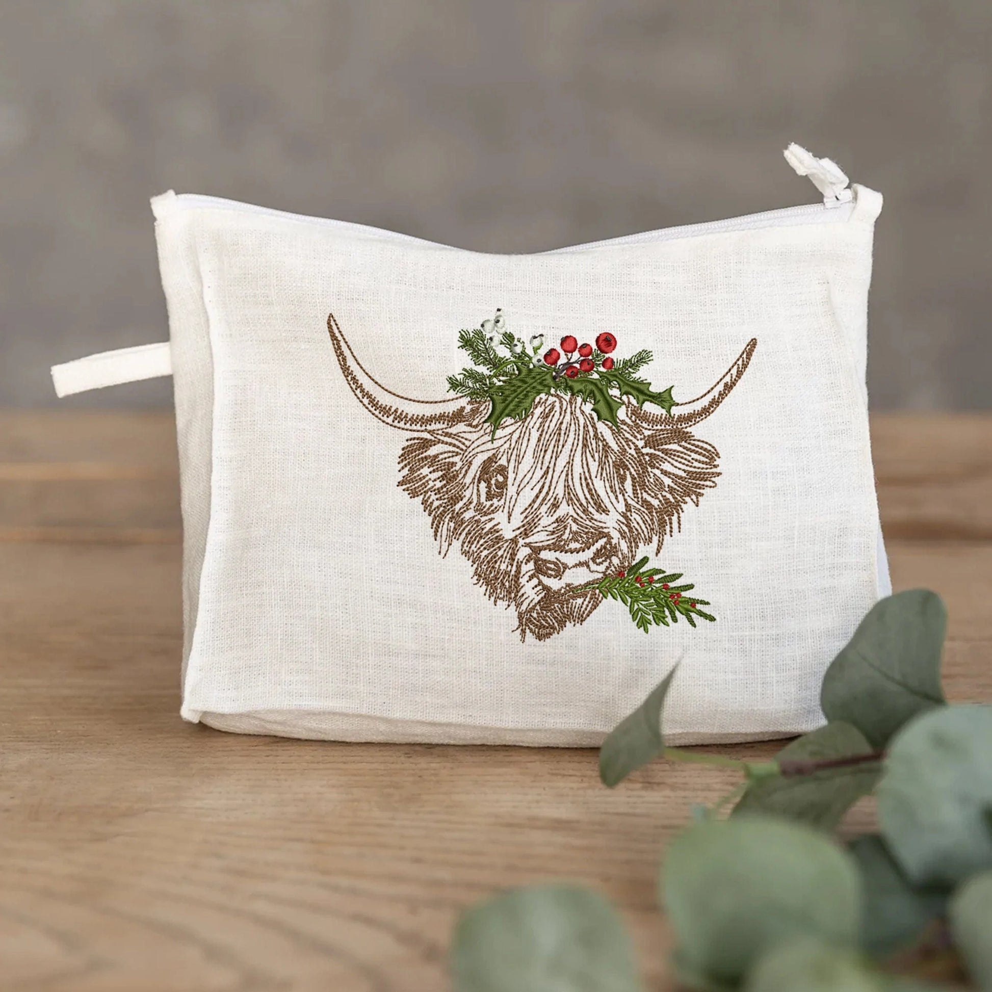 Christmas Highland Cow Machine Embroidery Design on cosmetic pouch